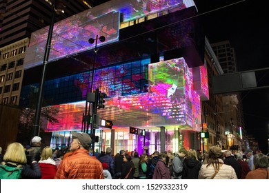 Cincinnati, Ohio / United States -October 12, 2019: Crowd of people in front of a video art projection over the Contemporary Art Museum at Blink 2019 event in Cincinnati.