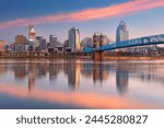 Cincinnati, Ohio, USA. Cityscape image of Cincinnati, Ohio, USA downtown skyline with the John A. Roebling Suspension Bridge and reflection of the city in the Ohio River at spring sunrise.