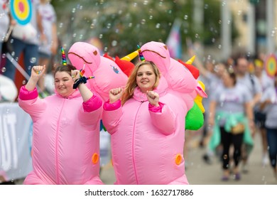 Cincinnati, Ohio, USA - June 22, 2019: The Cincinnati Pride Parade, Two Women, Wearing Unicorn Outfits Dancing During The Parade