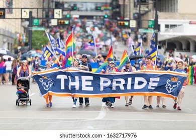 Cincinnati, Ohio, USA - June 22, 2019: The Cincinnati Pride Parade, People Waving Rainbow Flags, And Carrying Banner Promoting FC Cincinnati