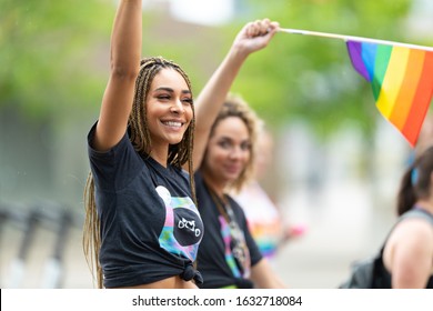 Cincinnati, Ohio, USA - June 22, 2019: The Cincinnati Pride Parade, Young Women Waving The Rainbow Flag, Promoting Oggo