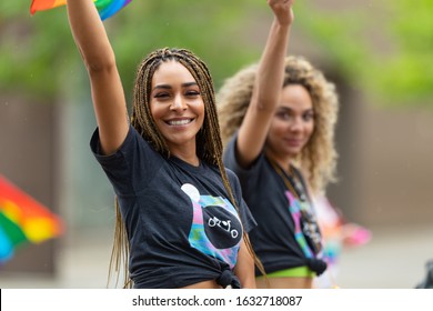 Cincinnati, Ohio, USA - June 22, 2019: The Cincinnati Pride Parade, Young Women Waving The Rainbow Flag, Promoting Oggo