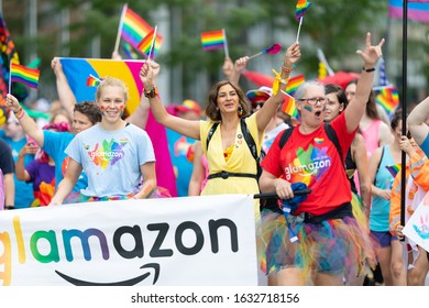 Cincinnati, Ohio, USA - June 22, 2019: The Cincinnati Pride Parade, Women Waving Rainbow Flags, Promoting Glamazon