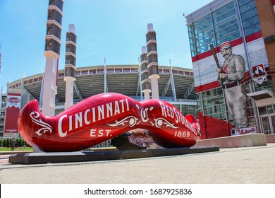 Cincinnati, Ohio / USA - June 24 2015: Close up of red mustache sculpture/bench with old fashioned Red Stockings branding for the 2015 All-Star Game with Great American Ballpark in background. 