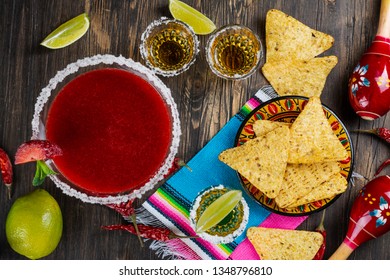 Cinco De Mayo Celebration Background. 5th May Mexican Party. Strawberry Mojito, Corn Nachos And Tequila Shots With Lime On Wooden Table