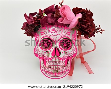 cinco de mayo celebration image of human skull with pink mask overlay and flower head dress