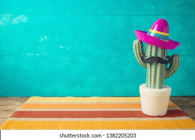 Cinco de Mayo holiday background with Mexican cactus and  party sombrero hat on wooden table  - Shutterstock ID 1382205203