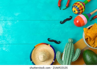 Cinco De Mayo Holiday Background With Mexican Cactus, Nachos Chips, Maracas And Party Sombrero Hat. Top View, Flat Lay