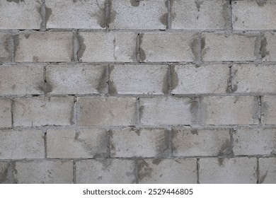 A cinder block wall texture with gray and white colors.