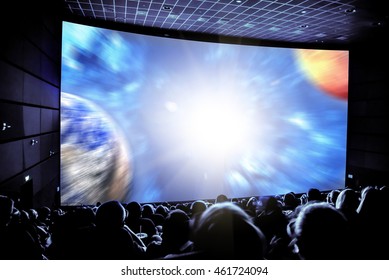 Cinema. The audience in 3D glasses watching a movie. Elements of this image furnished by NASA.