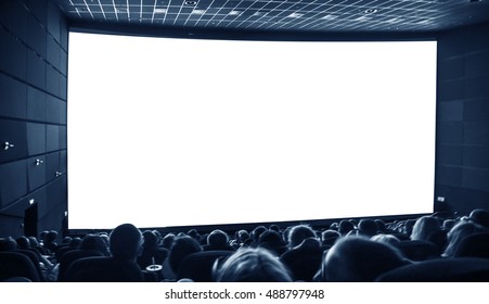 Cinema. The Audience In 3D Glasses Watching A Movie. A White Screen For Your Image.