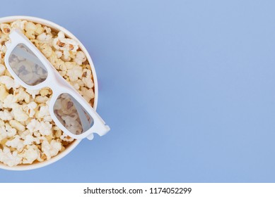 Cinema Concept. Flat lay. Copyspace. Cinema Concept. Background. 3d glasses and cup with popcorn isolated on a pastel blue background.