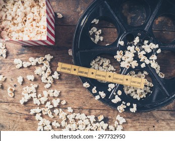 Cinema Concept Of Vintage Film Reel With Popcorn And Movie Tickets