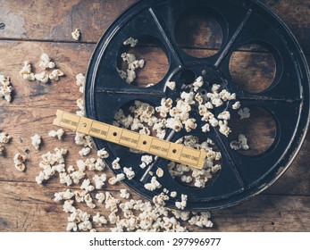 Cinema Concept Of Vintage Film Reel With Popcorn And Movie Tickets