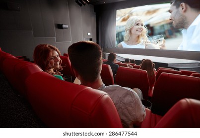 cinema, entertainment, communication and people concept - happy couple of friends watching movie and talking in theater from back - Powered by Shutterstock