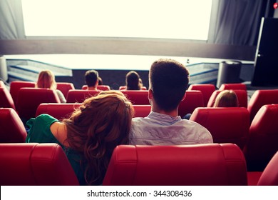 Cinema, Entertainment, Leisure And People Concept - Happy, Couple Watching Movie In Theater From Back