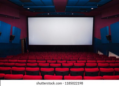 Cinema Interior Of Movie Theatre With Empty Red And Black Seats With Copyspace On The Screen