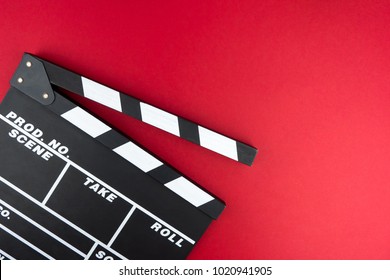 Cinema Minimal Concept. Watching Film In The Cinema. Clapper Board On Red Background. Screenwrite Desktop