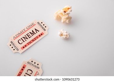 Cinema Moments Concept With Popcorn And Movie Tickets On White Table. Horizontal Composition. Top View.