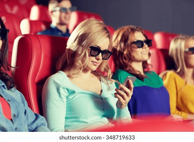 cinema, technology, entertainment and people concept - happy woman with 3d glasses and smartphone reading message in movie theater - Powered by Shutterstock