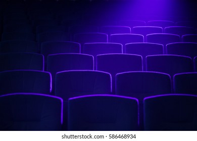 Cinema  theater seats with projection light falling into the lens 