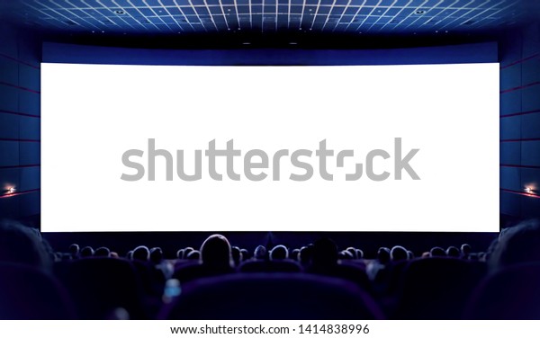 Cinema. White screen in the cinema and the\
audience watching the\
movie.