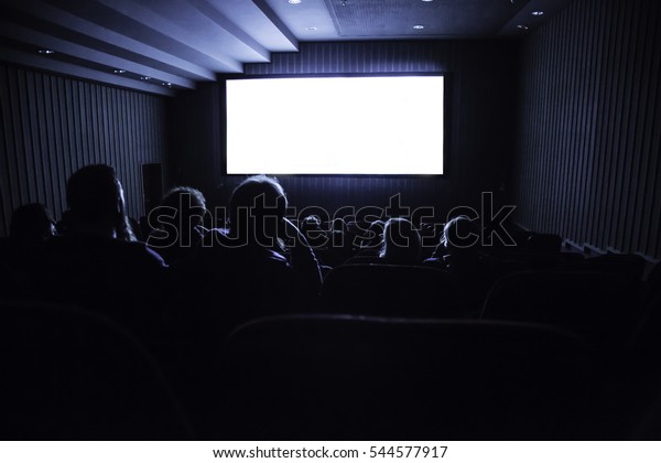 cinema\
white screen with seats and people\
silhouettes