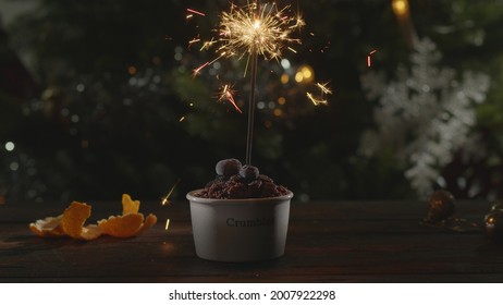 Cinemagraph - Close-up shot of bright burning sparkler in berry crumble dessert. Spirit of Christmas and New Year