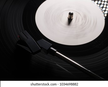 Cinemagraph, retro vinyl player. Recorder on turntable, viewed from above. Close-up. Pick-up lifts off.