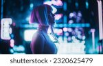 Cinematic Arc Shot of a Stylish Young Cosplay Model with Blue Hair Wandering Around a Futuristic Cybernetic City with Neon Lights. Young Excited Female in a Cyberpunk Virtual Reality