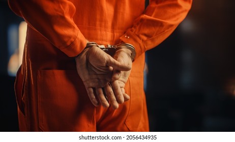 Cinematic Close Up Footage of a Handcuffed Convict at a Law and Justice Court Trial. Handcuffs on Accused Criminal in Orange Jail Jumpsuit. Law Offender Sentenced to Serve Jail Time. - Shutterstock ID 2056434935