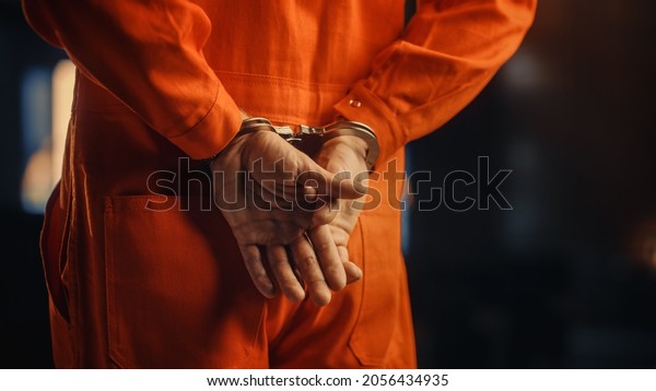 Cinematic Close Up\
Footage of a Handcuffed Convict at a Law and Justice Court Trial.\
Handcuffs on Accused Criminal in Orange Jail Jumpsuit. Law Offender\
Sentenced to Serve Jail\
Time.