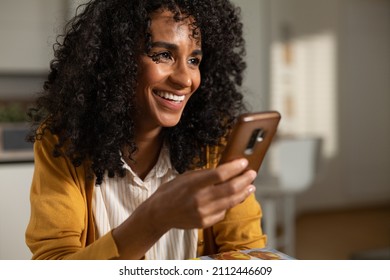 Cinematic Close Up Shot Of Young Happy Smiling Brazilian Woman Is Using Technology Smartphone For Work Or Entertainment In Living Room At Home.