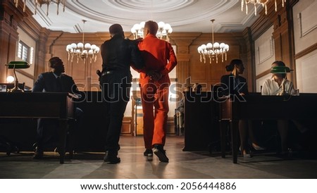 Cinematic Court of Law and Justice Trial Proceedings: Portrait of Accused Male Criminal in Orange Jumpsuit Led Away by Security Guard in Front of Jury. Convict Sentenced to Serve Jail Time.