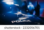 Cinematic Focus on Patrol Car: Two Police Officers Arrest Suspect, Put Him in Vehicle. Officers of the Law Handcuff Dangerous Criminal on Dark City Street. Cops Fight Crime. Documentary Shot