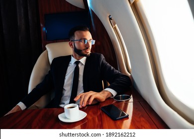 Cinematic Image Of A Businessman Flying On His Private Jet. Concept About Business, And Transportation