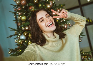 Cinematic Image Of A Couple Celebrating Christmas At Home. Boyfriend And Girlfriend Spending Time Together On The New Year Evening And Sharing Positive Vibes. 