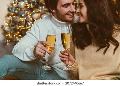 Cinematic Image Of A Couple Celebrating Christmas At Home. Boyfriend And Girlfriend Spending Time Together On The New Year Evening And Sharing Positive Vibes. 