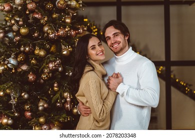 Cinematic Image Of A Couple Celebrating Christmas At Home. Boyfriend And Girlfriend Spending Time Together On The New Year Evening And Sharing Positive Vibes. 