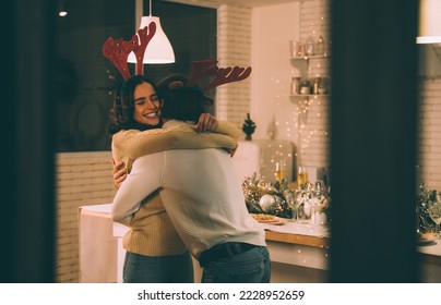 Cinematic image of a couple celebrating christmas at home. Boyfriend and girlfriend spending time together on the new year evening and sharing positive vibes.  - Powered by Shutterstock