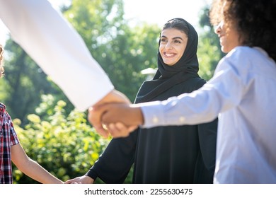 Cinematic image of a family from the emirates spending time at the park - Powered by Shutterstock