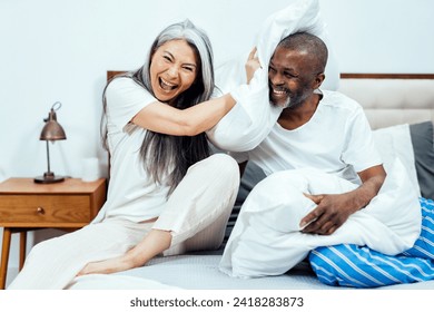 Cinematic image of an happy multiethnic senior couple. Indoors Lifestyle moments at home. Concept about seniority and relationships - Powered by Shutterstock