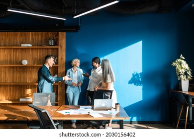 Cinematic Image Of A Multiethnic Business Team. Group Of Employees Working Together On A Project In The Office