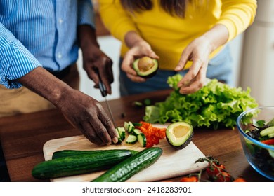 cinematic image of a multiethnic senior couple preparing food in the kitchen. Indoors Lifestyle moments at home. Concept about seniority and relationships - Powered by Shutterstock