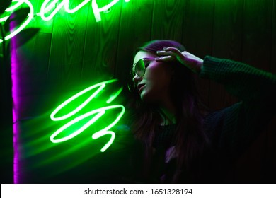 Cinematic Night Portrait Of A Girl And Neon Lights. Green Neon