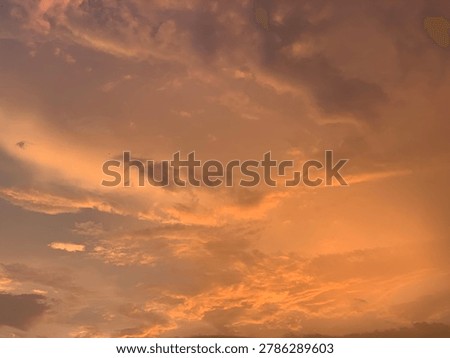 Cinematic orange sunset clouds with dramatic pastel sky and soft texture, captured in wide-angle focus. Perfect for luxury branding, wellness ads, travel banners and aesthetic wallpapers.