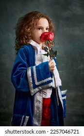Cinematic portair of beautiful little girl dressed up as medieval knight, little prince over dark vintage style background, Fashion, beauty, emotions, theater concept. Eras comparison - Shutterstock ID 2257046721