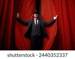 Cinematic posed portrait of magician actor over red velvet stage curtain