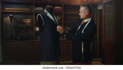 Cinematic Shot Of Professional Tailor Taking Measurements For Creation Of Custom High Quality Tailored Suit In Luxury Tailoring Atelier.Concept Of Fashion, Handmade, Hand Craft, Couturier And Business