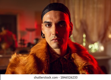 Cinematic Shot Of An Young Carefree Homosexual Male Gay Wearing Wig Cap Is Looking In Camera While Preparing In Vanity Room. Concept Of Gender Expression, Identity And Diversity.